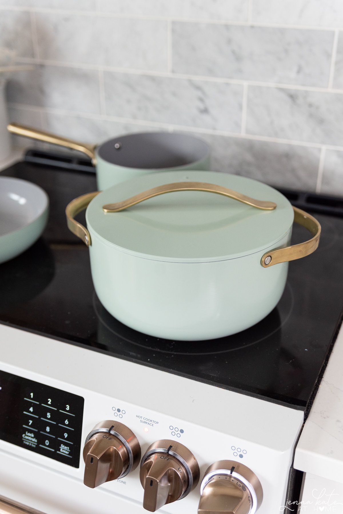 mint green Caraway dutch oven on a stovetop
