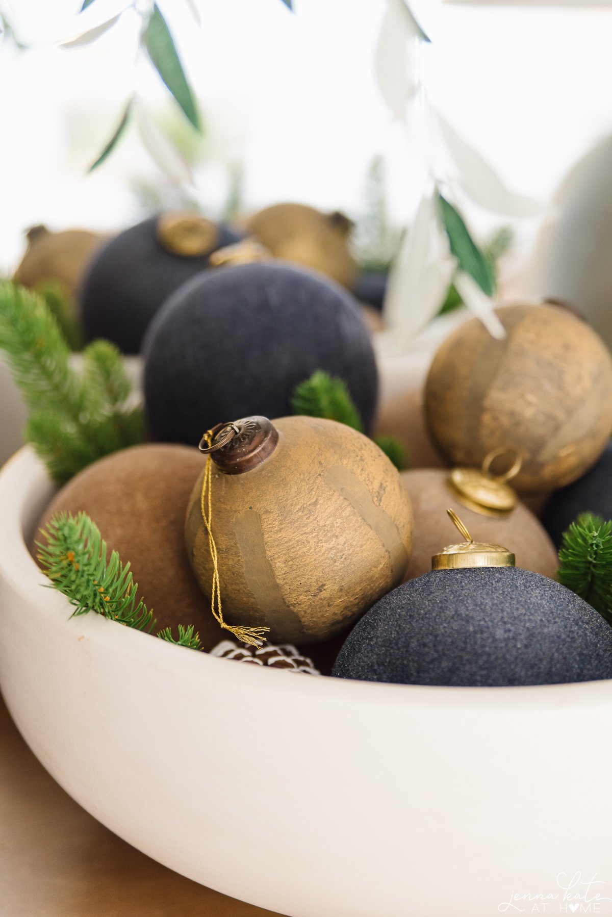 gold,  beige and blue ornaments in a large bowl
