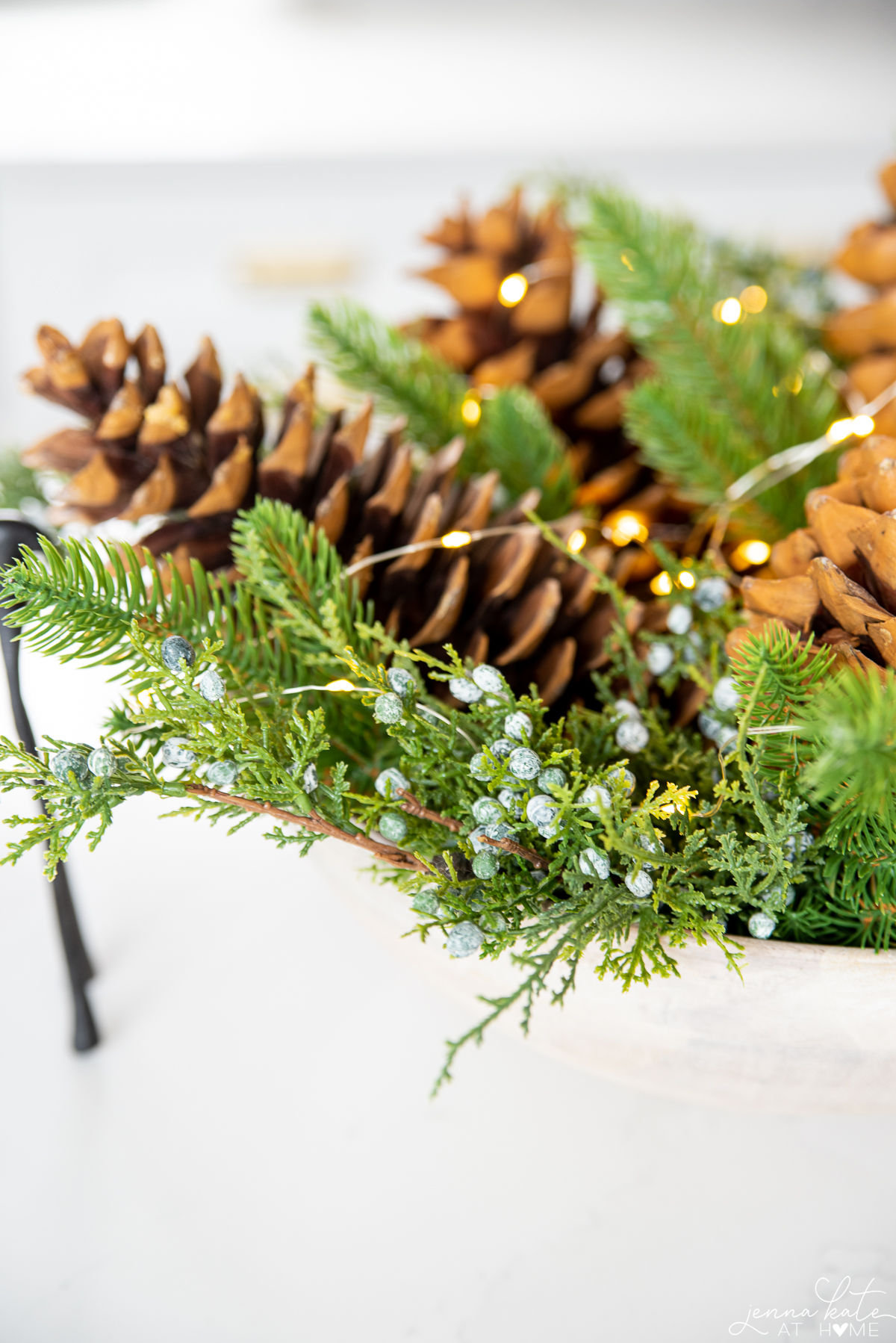centerpiece filled with juniper and large pinecones
