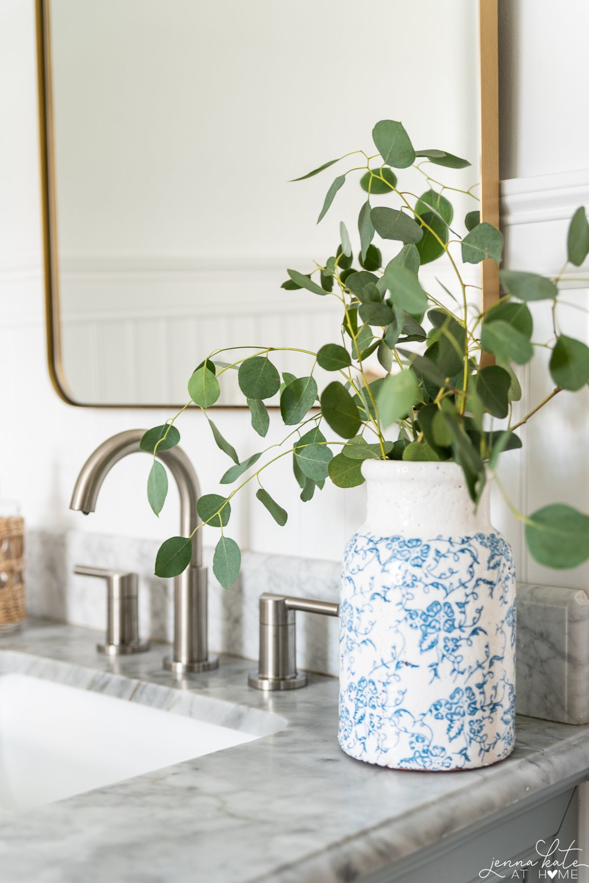 vase of eucalyptus stems on the bathroom vanity