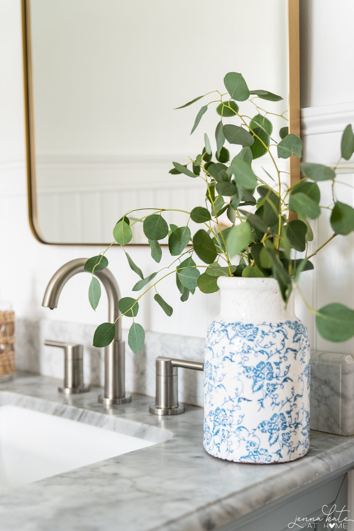 satin nickel faucet and brass mirror