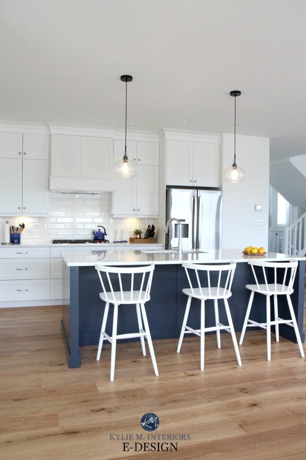 Bright white kitchen with Pure White walls, ceiling, and cabinets with a Naval blue island. 