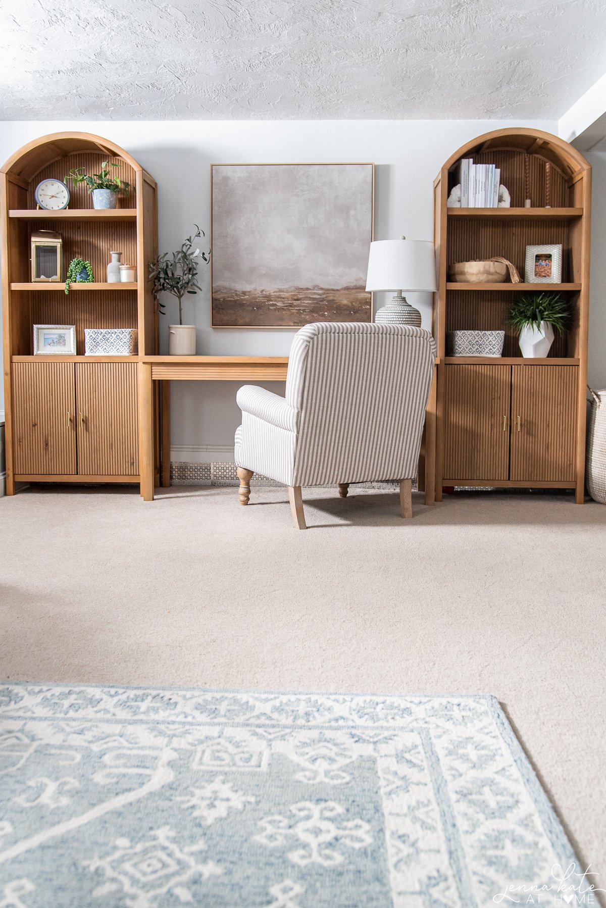 basement work space with blue gray walls and wooden bookcases