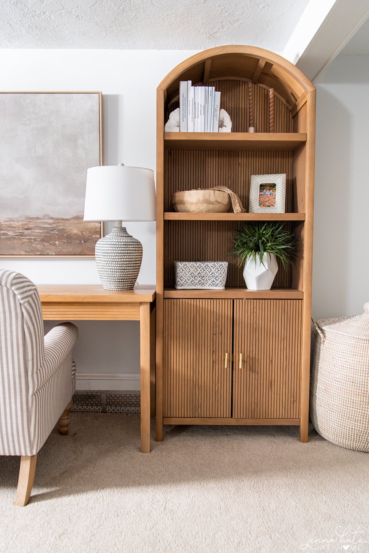 living space with a tall bookcase and seagrass  basket