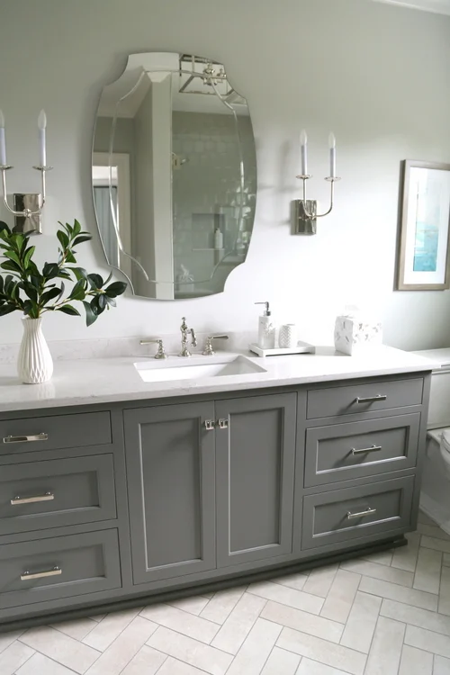 Grey bathroom vanity with white countertops