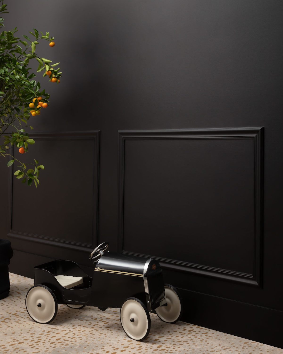 BM Black wall with neutral color carpet and little kids toy