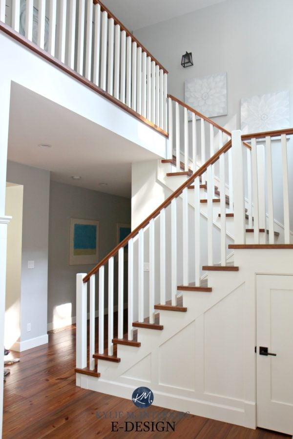 Staircase painted in Cloud White with cherry wood floors in the entrance way. 
