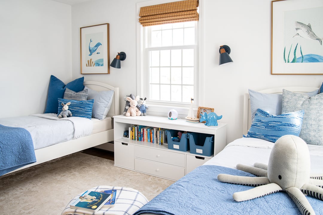 white toddler bedroom with blue accents