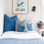 twin bed with blue throw pillows