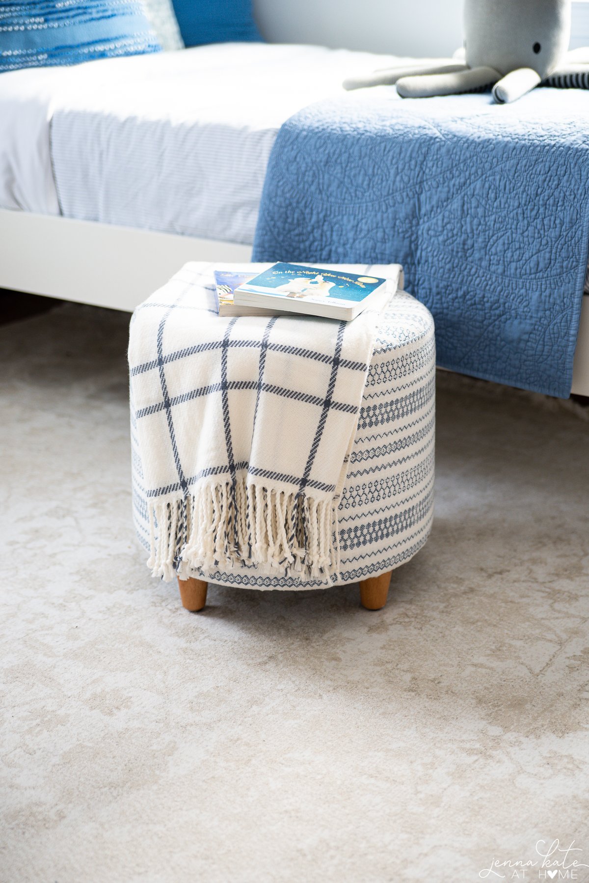 plaid blanket draped over a footstool