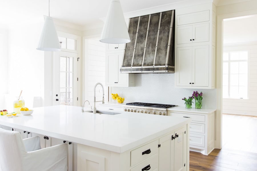 Bright white kitchen with Benjamin Moore China White walls and white cabinets and counter tops. 