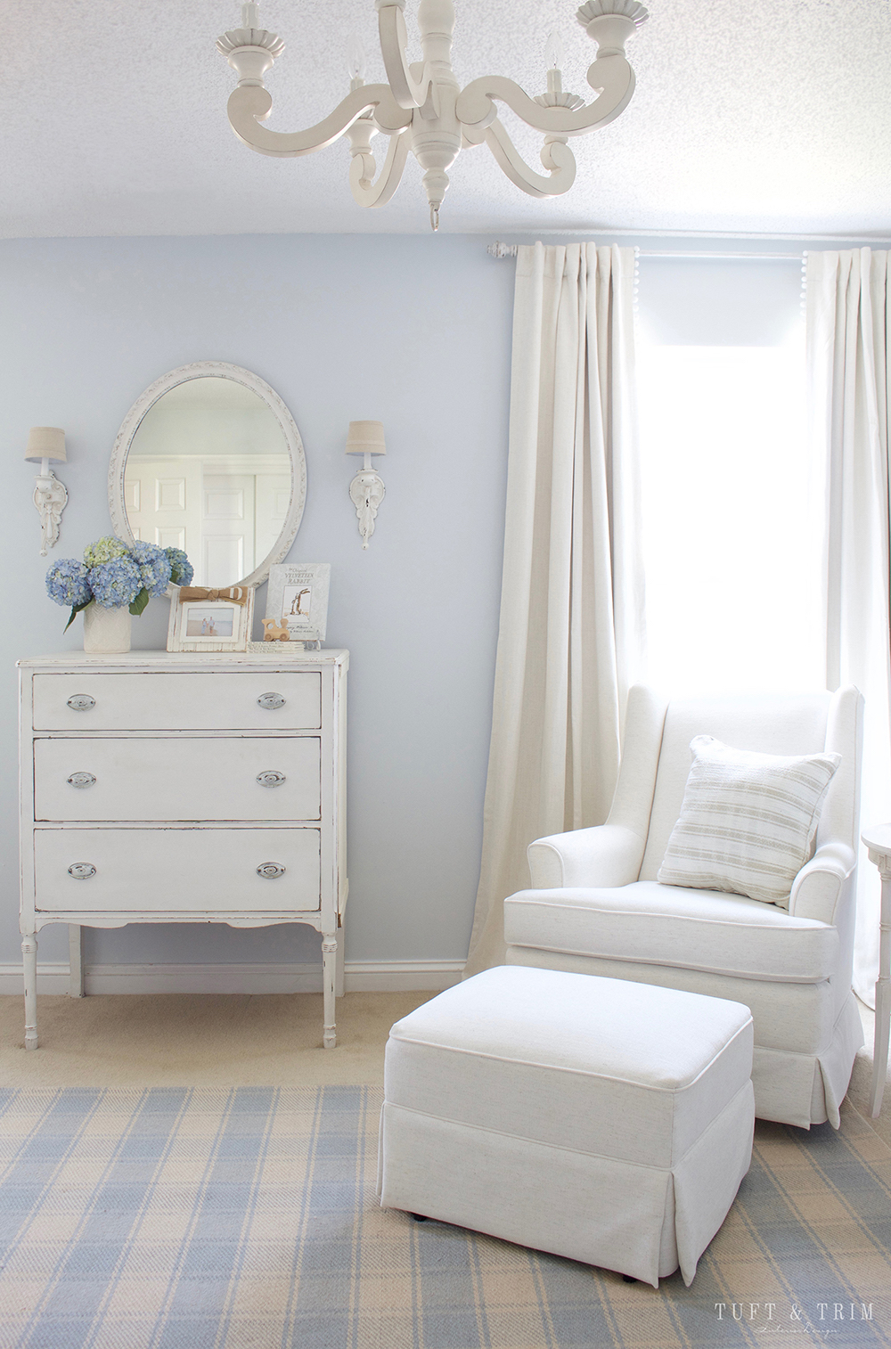 Light and airy nursery using Benjamin Moore First Snowfall on the walls with white furniture