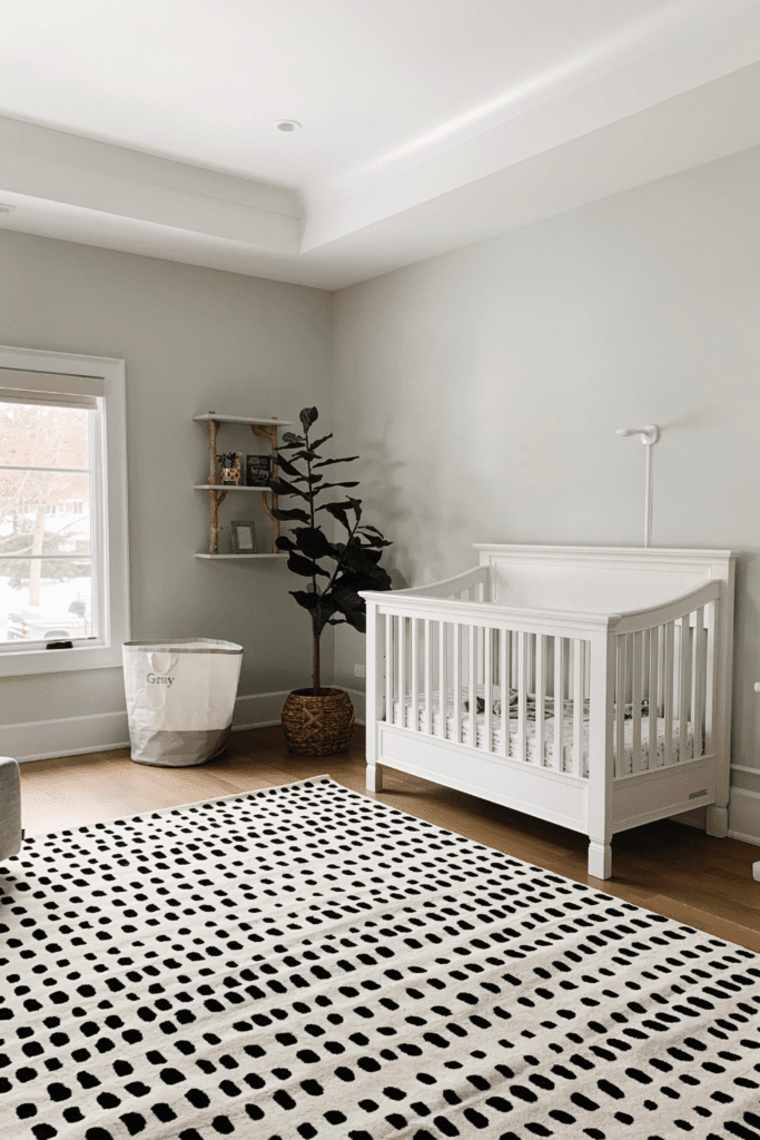 Neutral baby rooms using Benjamin Moore Paper White on the walls with black and white rug