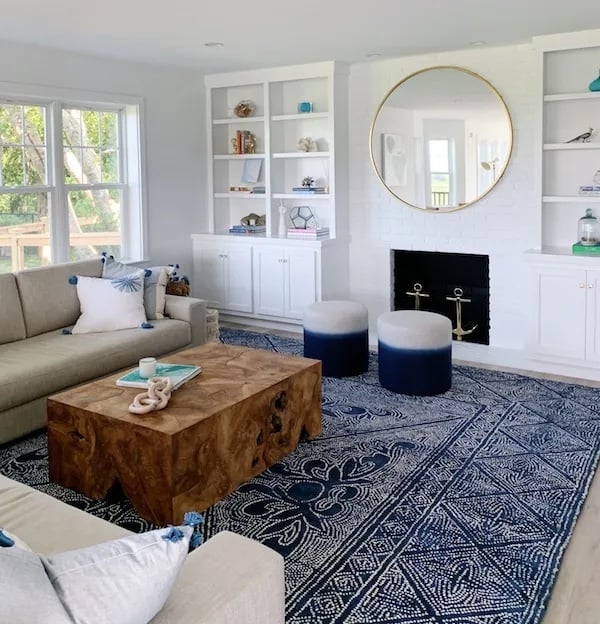 All white walls living room using BM White with blue carpet and wooded coffee table