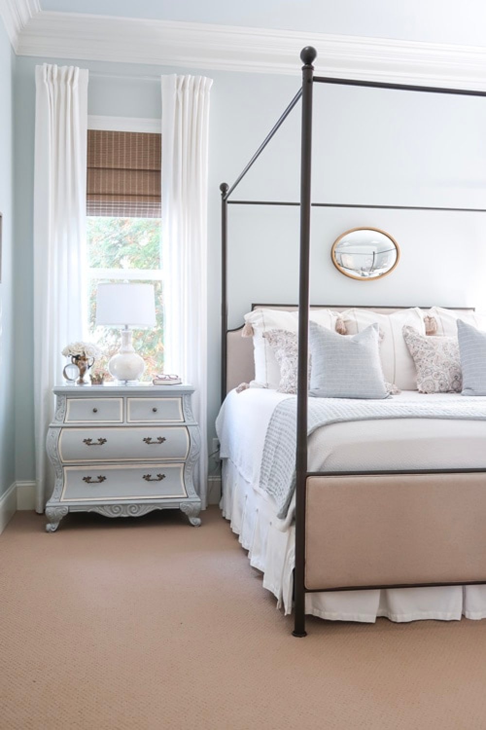 Bedroom with four poster bed, french style nightstand and walls painted Benjamin Moore Quiet Moments