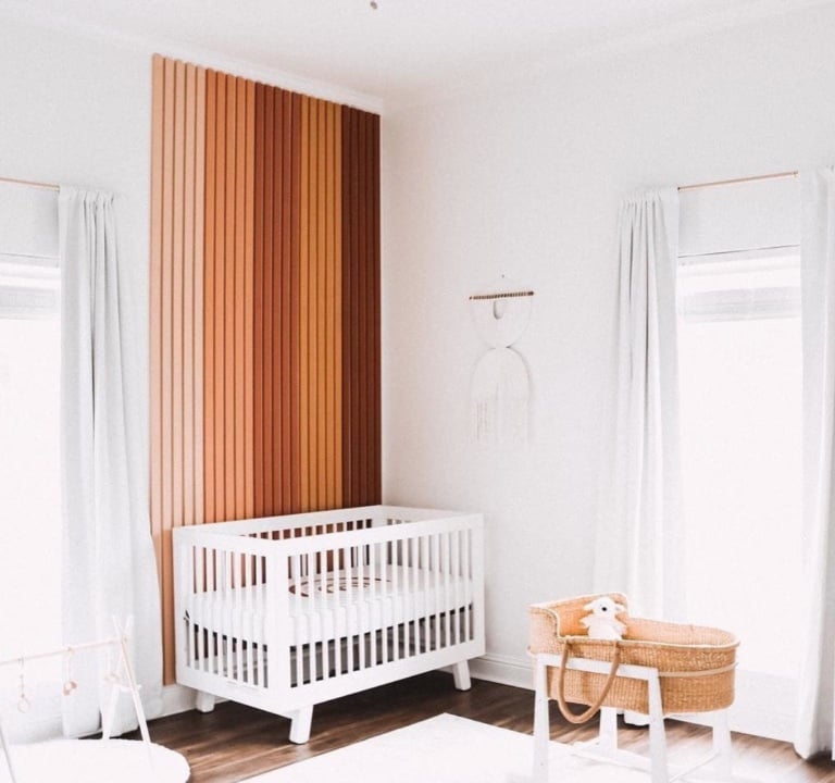 Retro nursery with wood accent wall. 