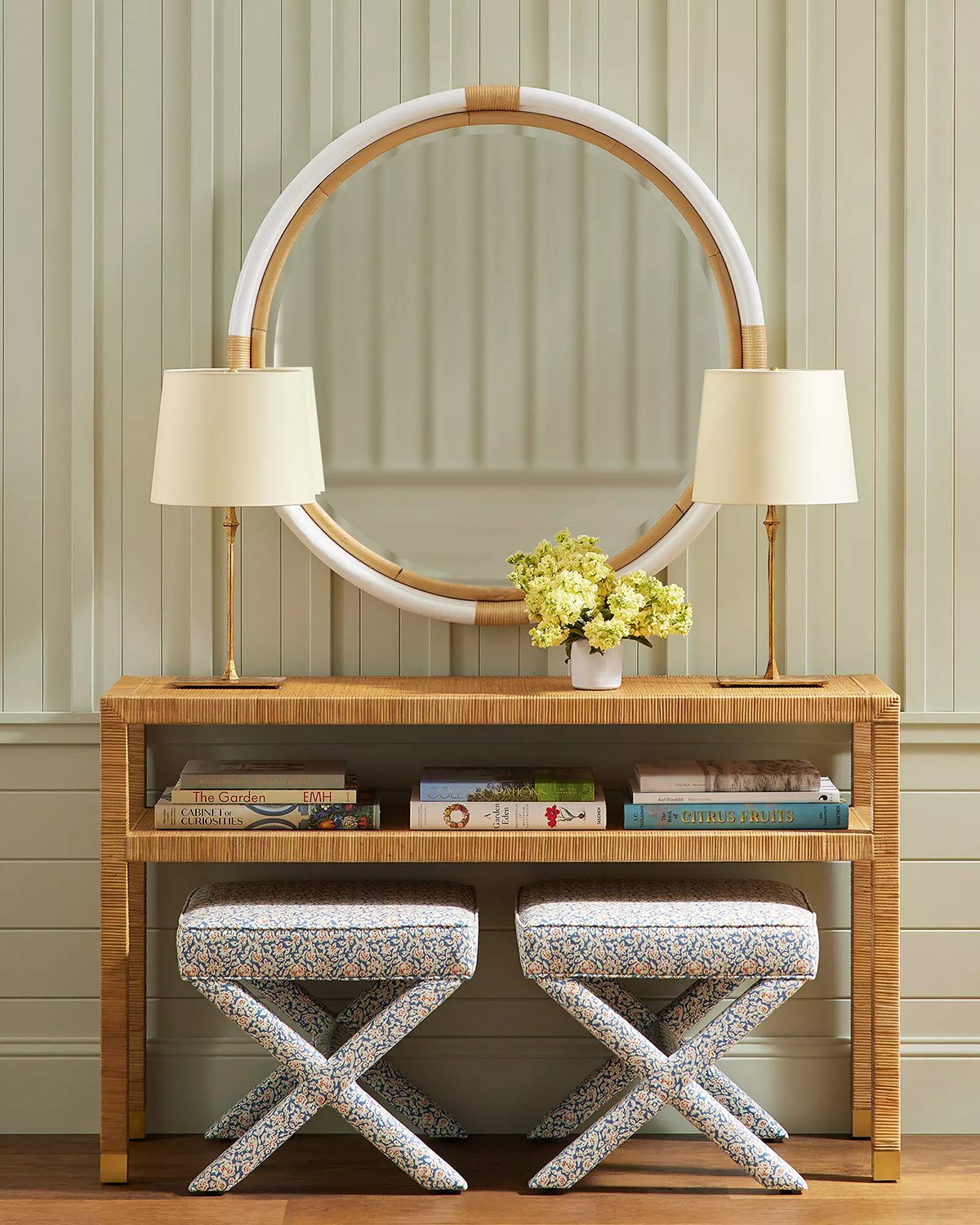 rattan console table with large round mirror, two lamps and x-base stools