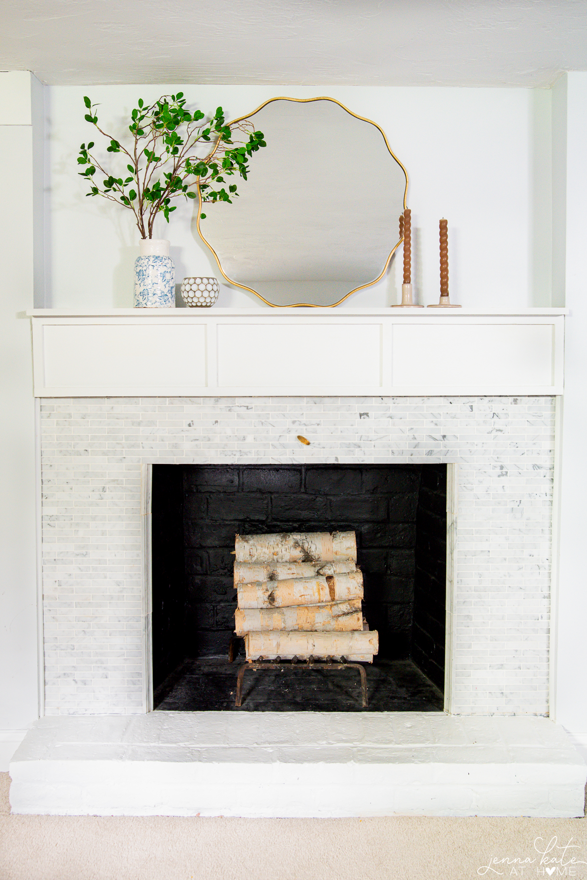 scalloped brass mirror over a fireplace mantel