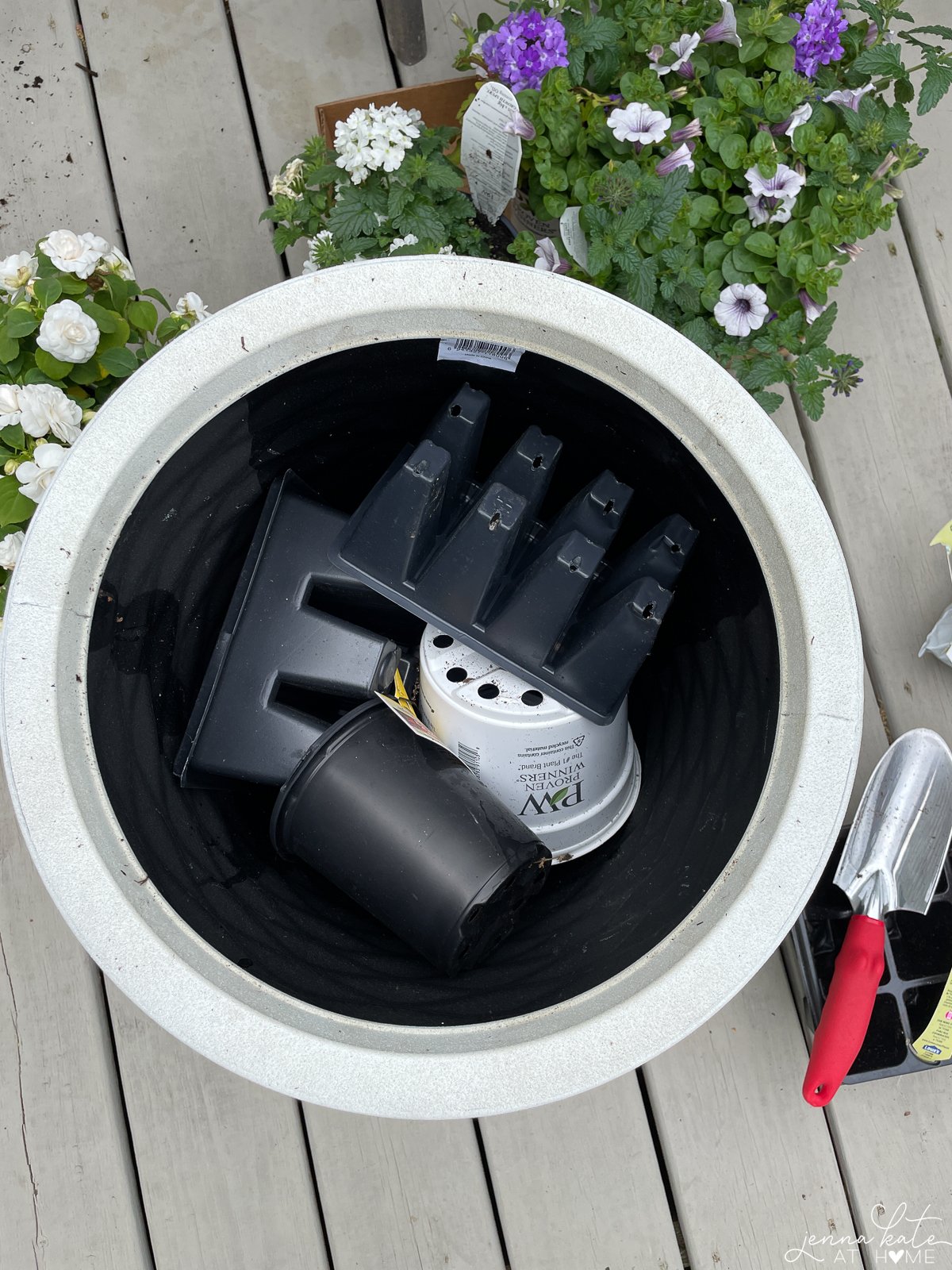 empty plastic planters in the bottom of a large planter