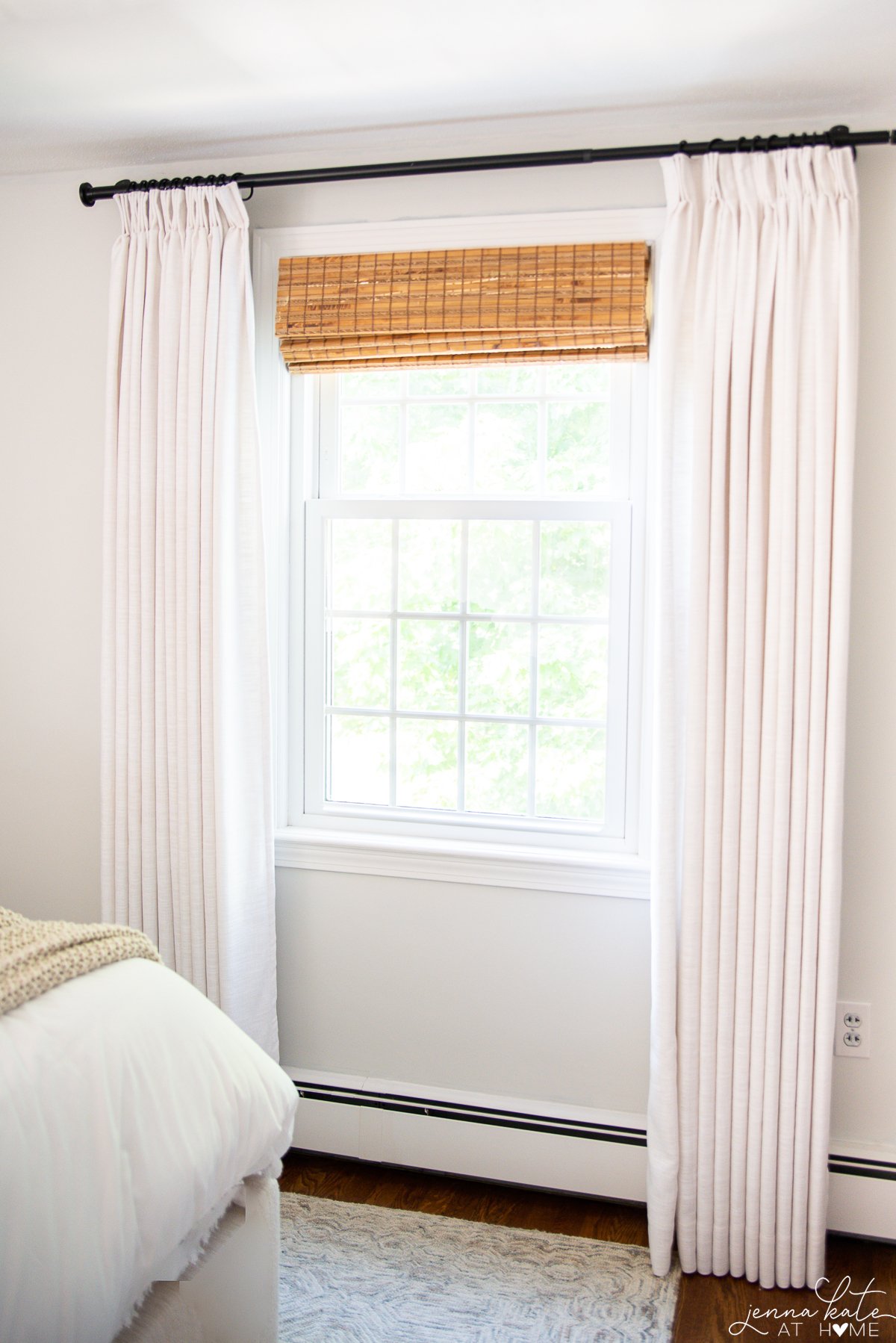 Amazon pinch pleat curtains in a bedroom with bamboo shades
