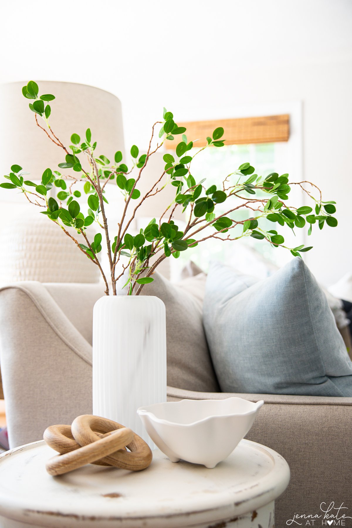 Frosted fluted vase with faux greenery stems from Amazon
