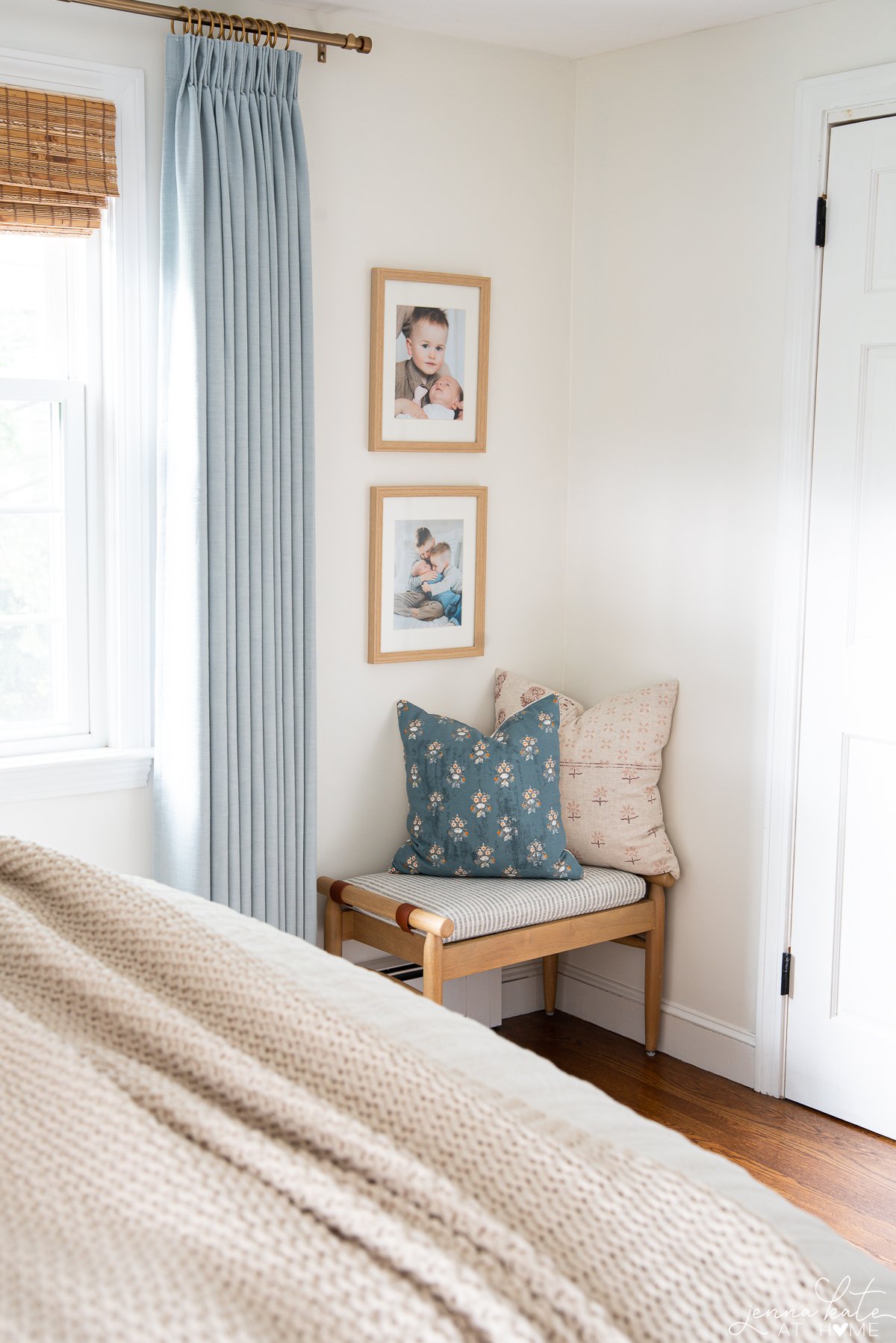 corner view of the bedroom with a bench with contrasting pillows