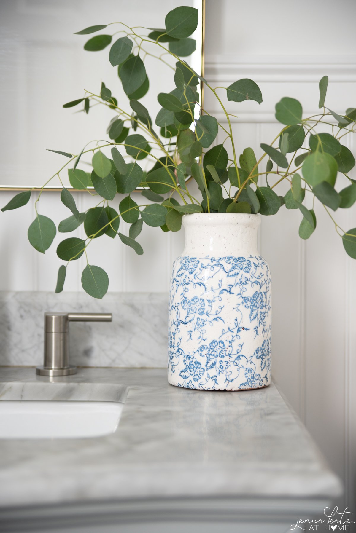 white and blue ceramic vase from Amazon on a bathroom countertop