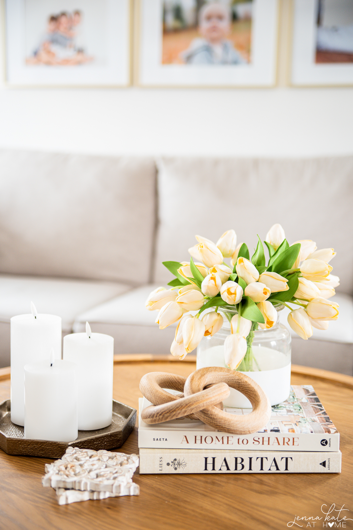 Coffee table books stacked with a vase of tulips sitting on top