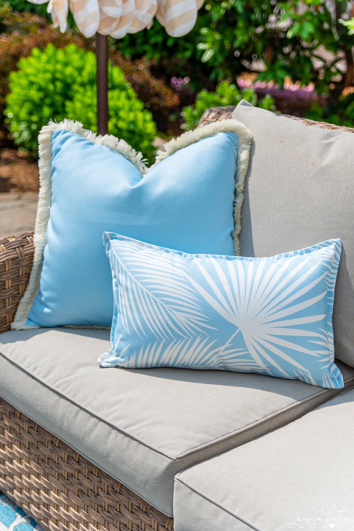 two sky blue pillows on the corner of an outdoor sofa