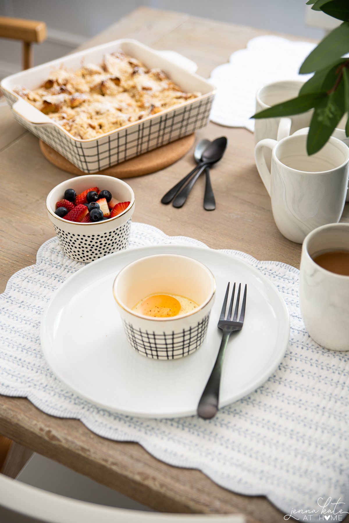 scalloped cotton placemats with a ramekin dish with a baked egg inside