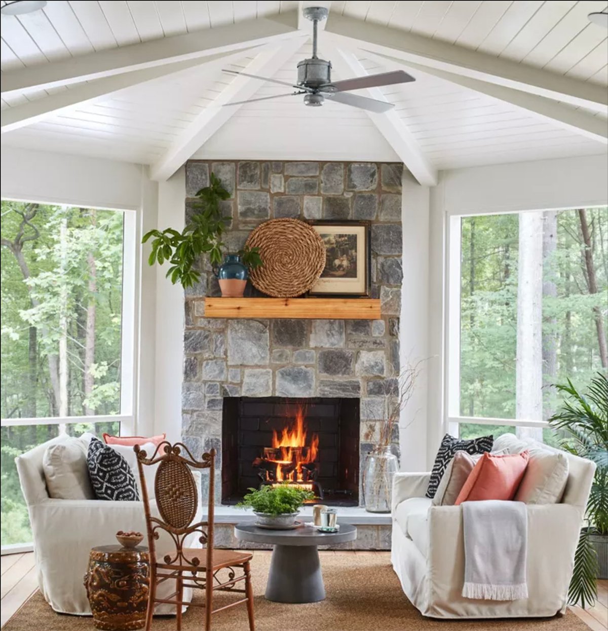 screened in porch with stone fireplace