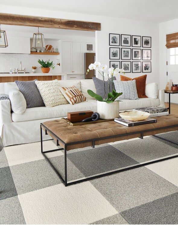 A living room with carpet tiles forming a grid pattern