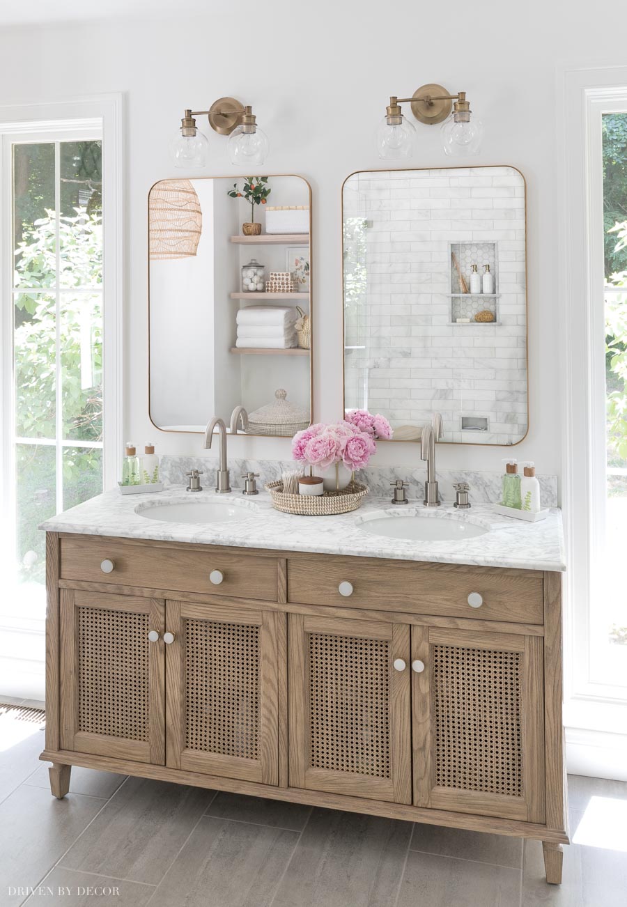 https://jennakateathome.com/wp-content/uploads/2023/07/master-bathroom-wood-double-vanity-mixed-metals.jpeg