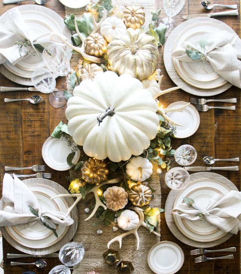 Beautiful neutral white and gold Thanksgiving table with white and gold pumpkins