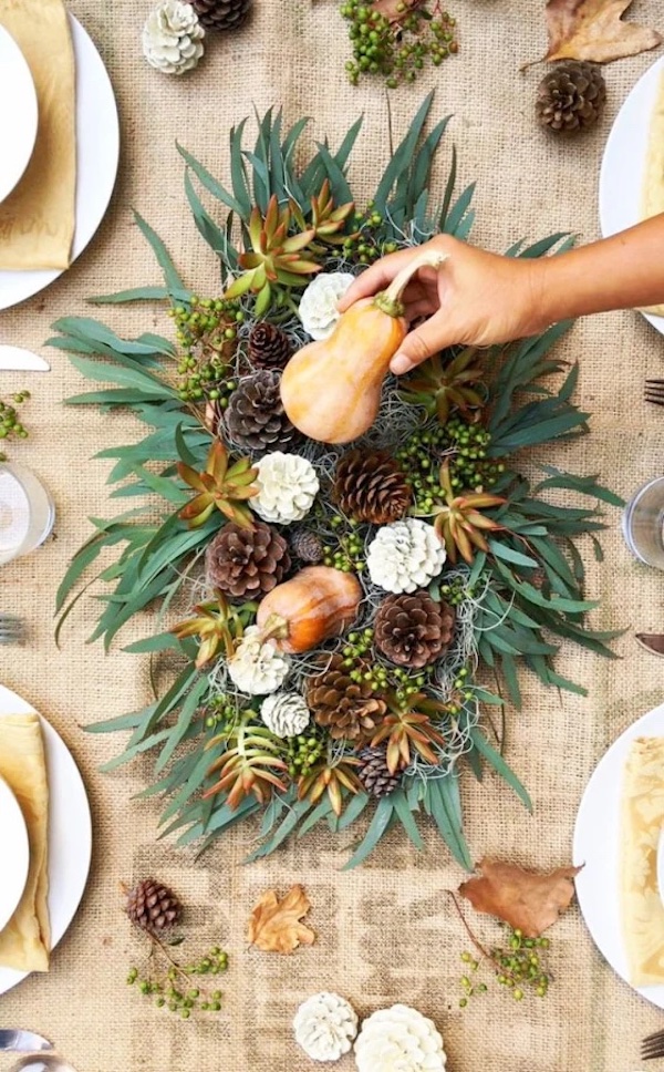 Natural elements like pinecones, leaves, and gourds as a centerpiece