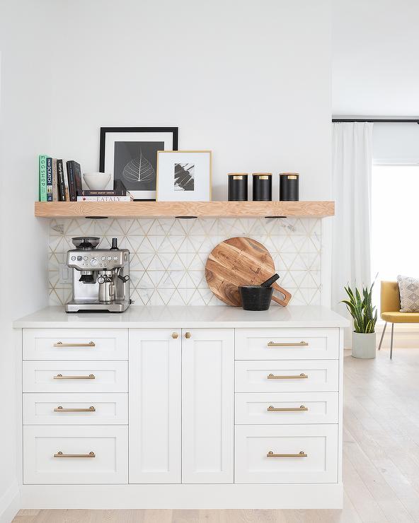 Coffee bar area with floating shelf and simple decor in a white kitchen 