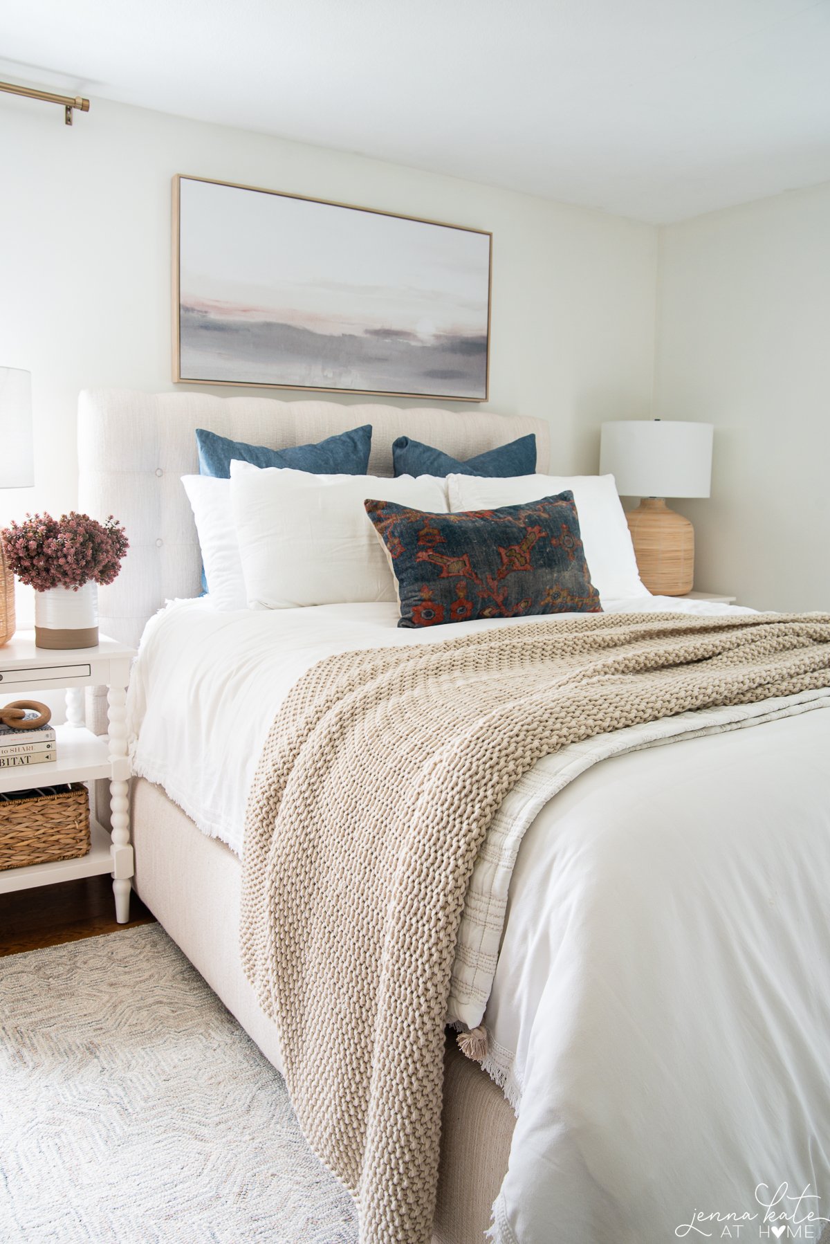 bed with blue and rust colored throw pillows for fall