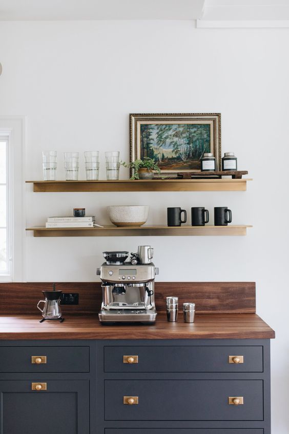 Coffee station on wooden kitchen counter with two floating shelves with accessories 