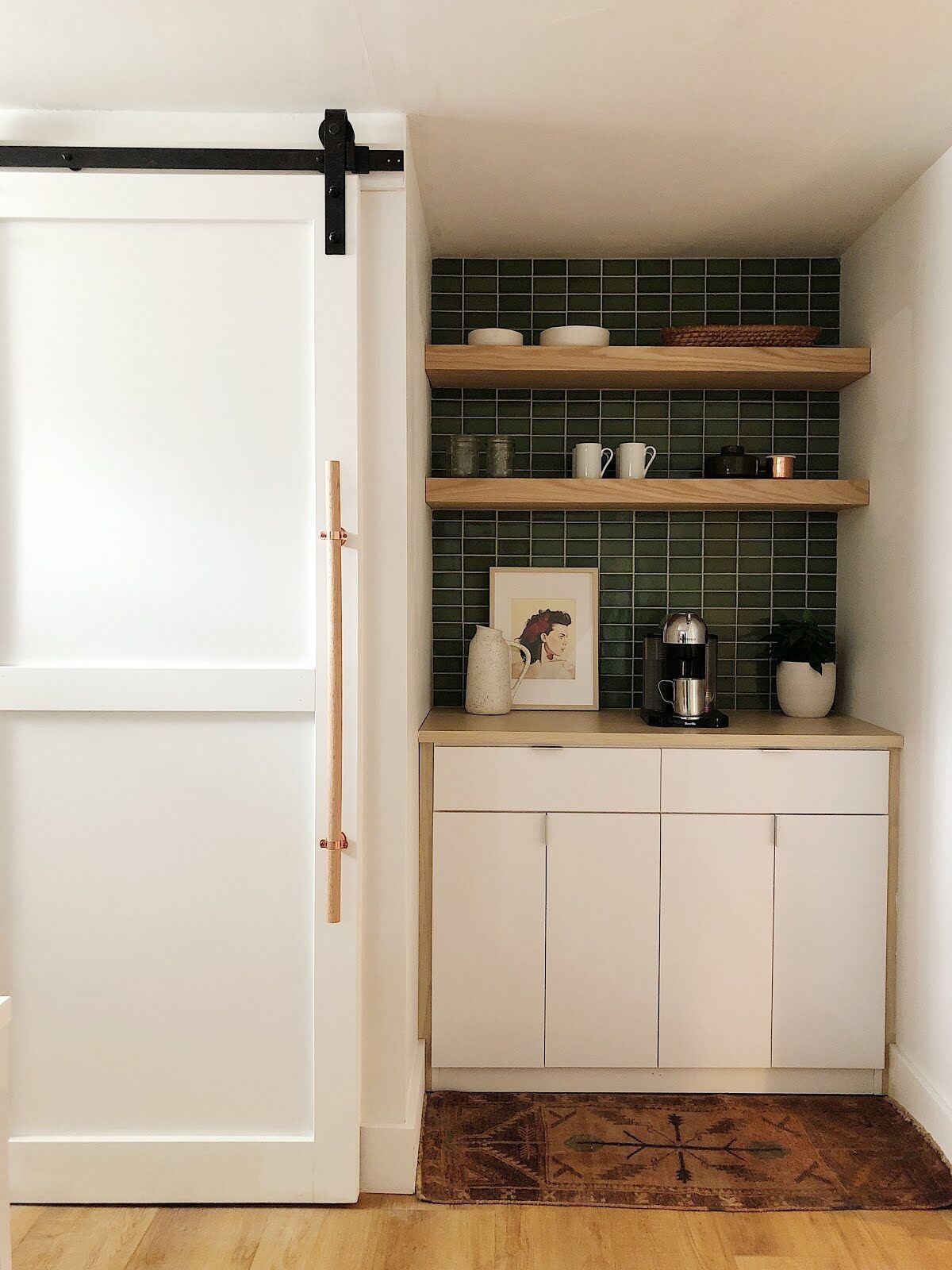 A simple coffee bar in the kitchen with extra storage using floating shelves