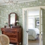 bedroom with dark wood dresser and green floral wallpaper