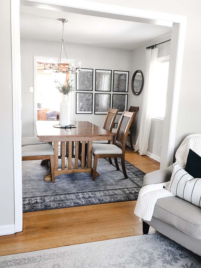 dining room walls painted a neutral color SW crushed ice with dark wood dining table