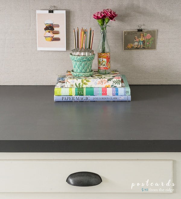 DIY painted laminate countertop with a stack of books 