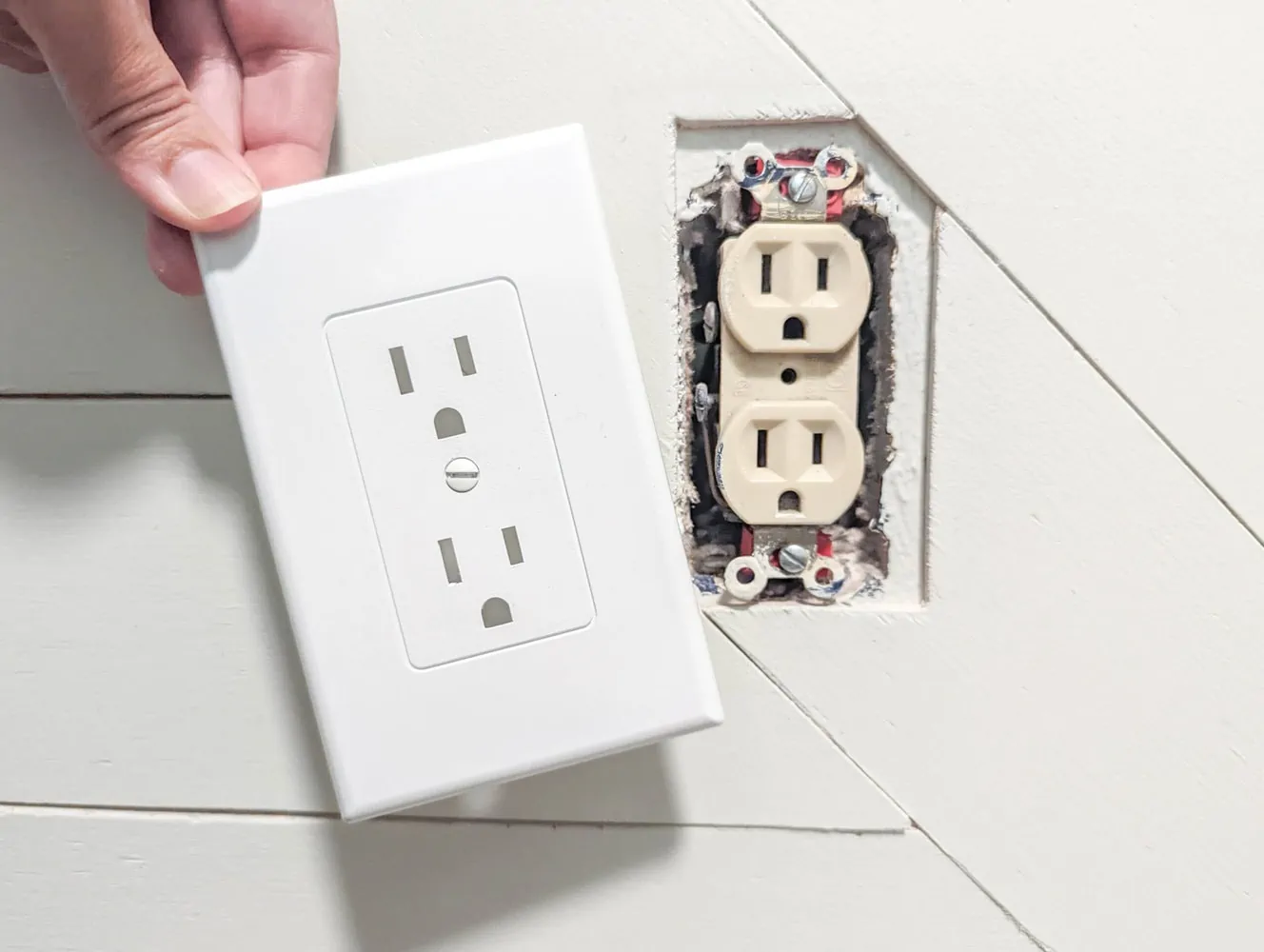 Woman replacing an outlet cover