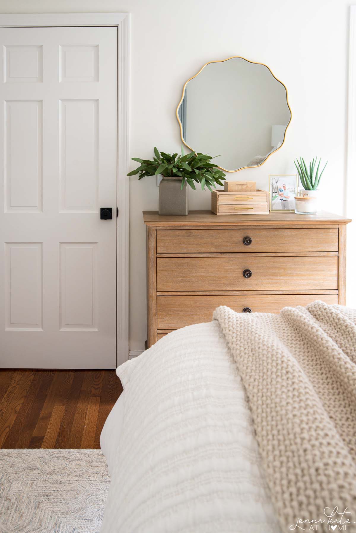 Wave mirror look for less over a white oak dresser