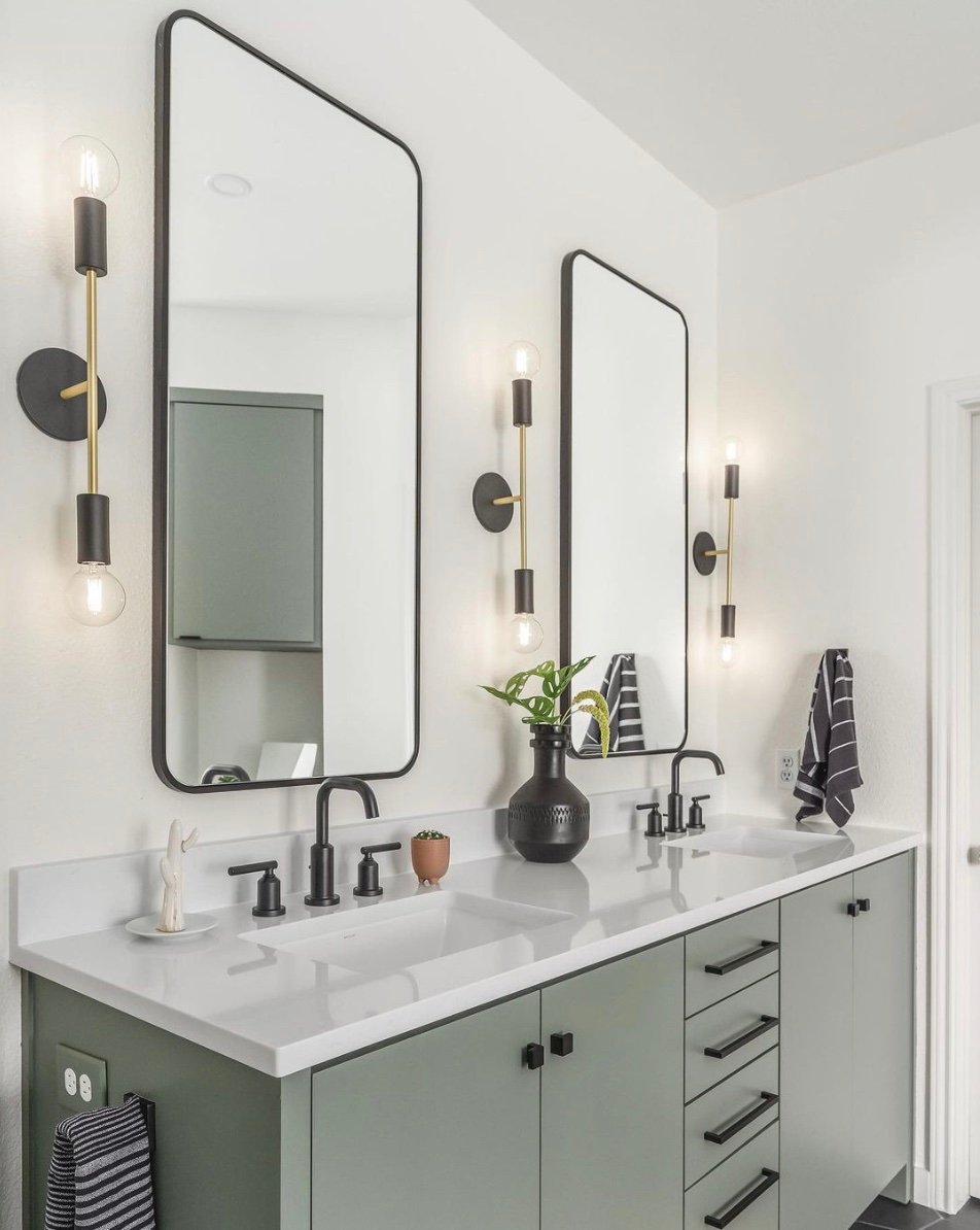 Sherwin Williams Retreat bathroom vanity with black hardware and black mirrors above.