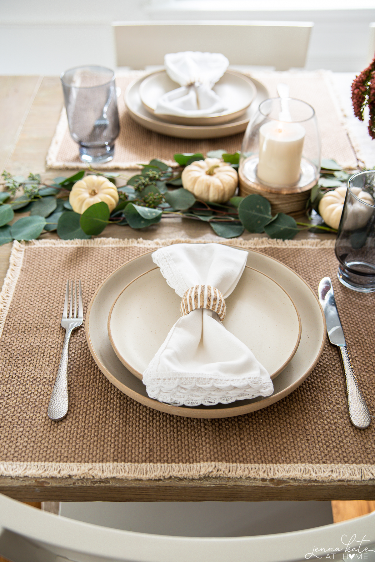 neutral placemats with neutral dinnerware and white napkin