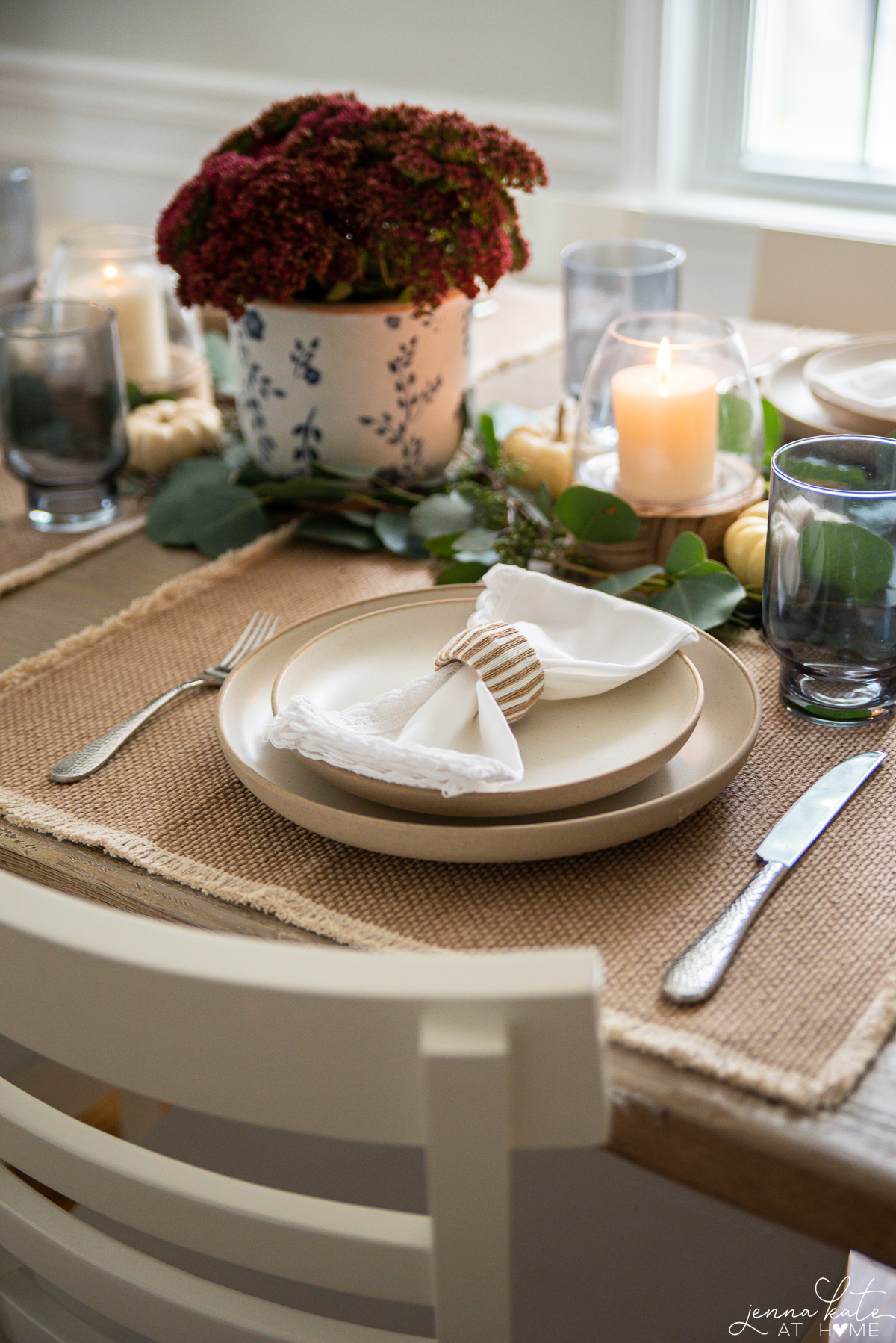 dinnerware set with white napkin on the plate and silverware on the placemat