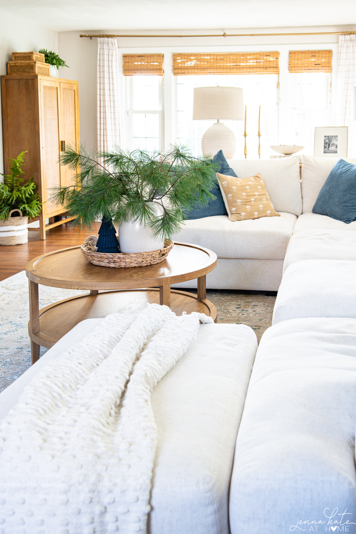 A living room minimally decorated for Christmas with blue and yellow accents.