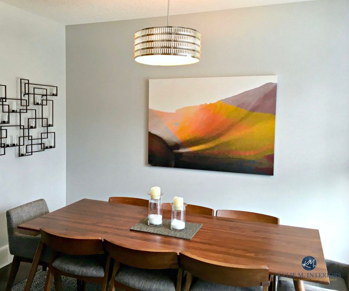 Big chill painted in a dining room with a wooden table and wall art hanging.