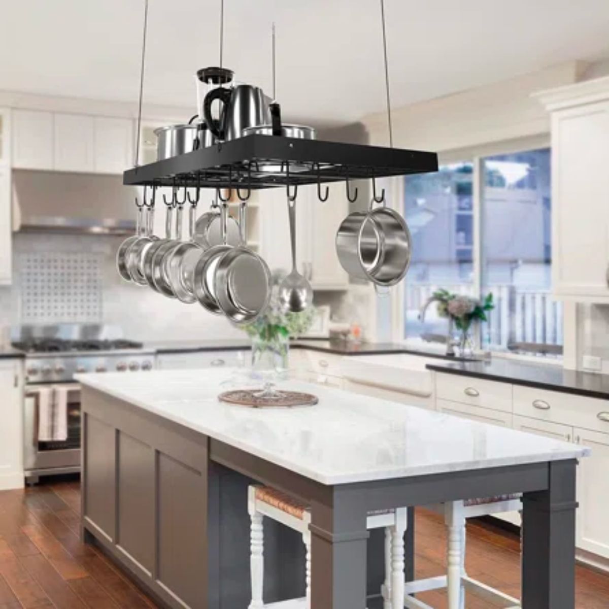 pots and pans hanging overhead of a kitchen island